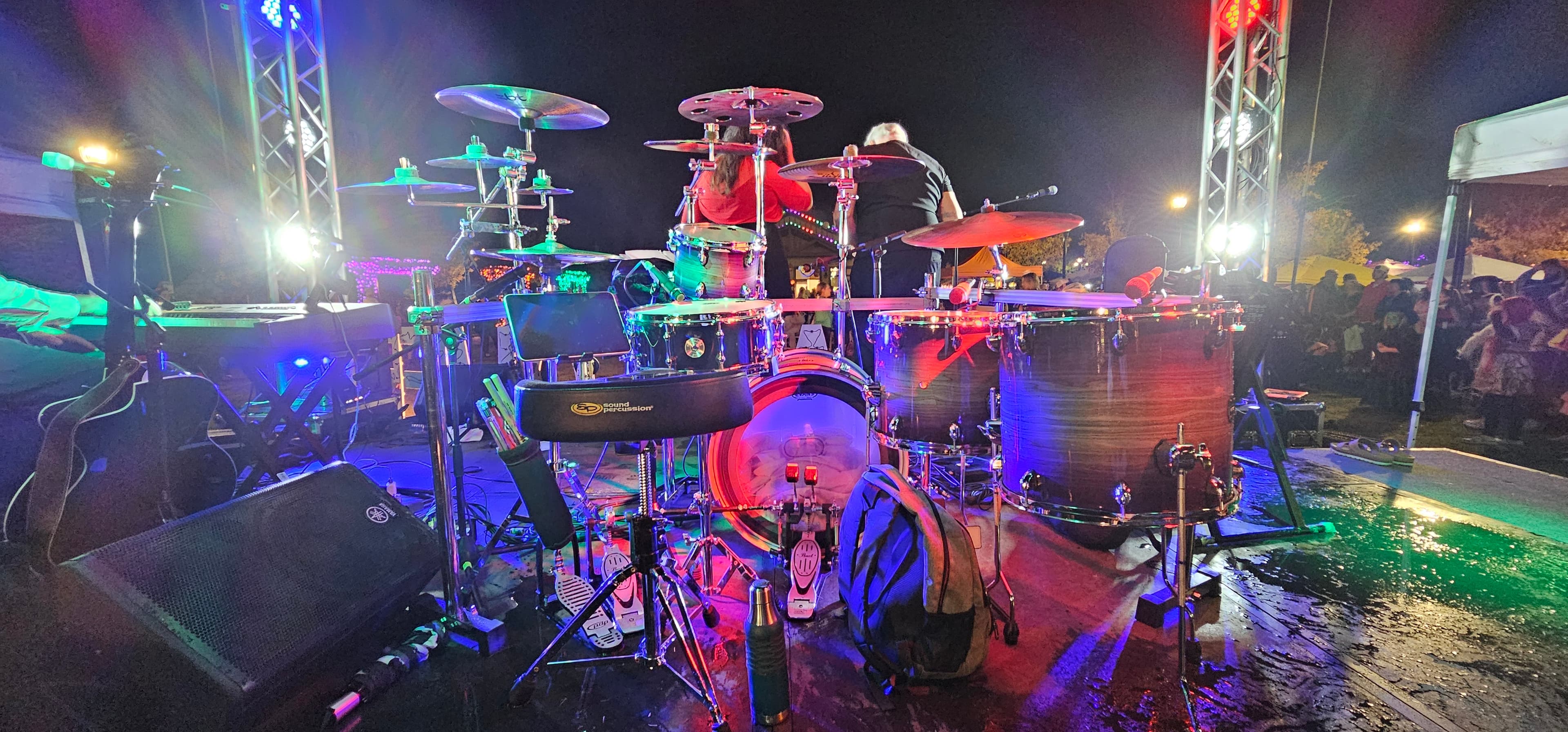Drum kit lit up on a night stage